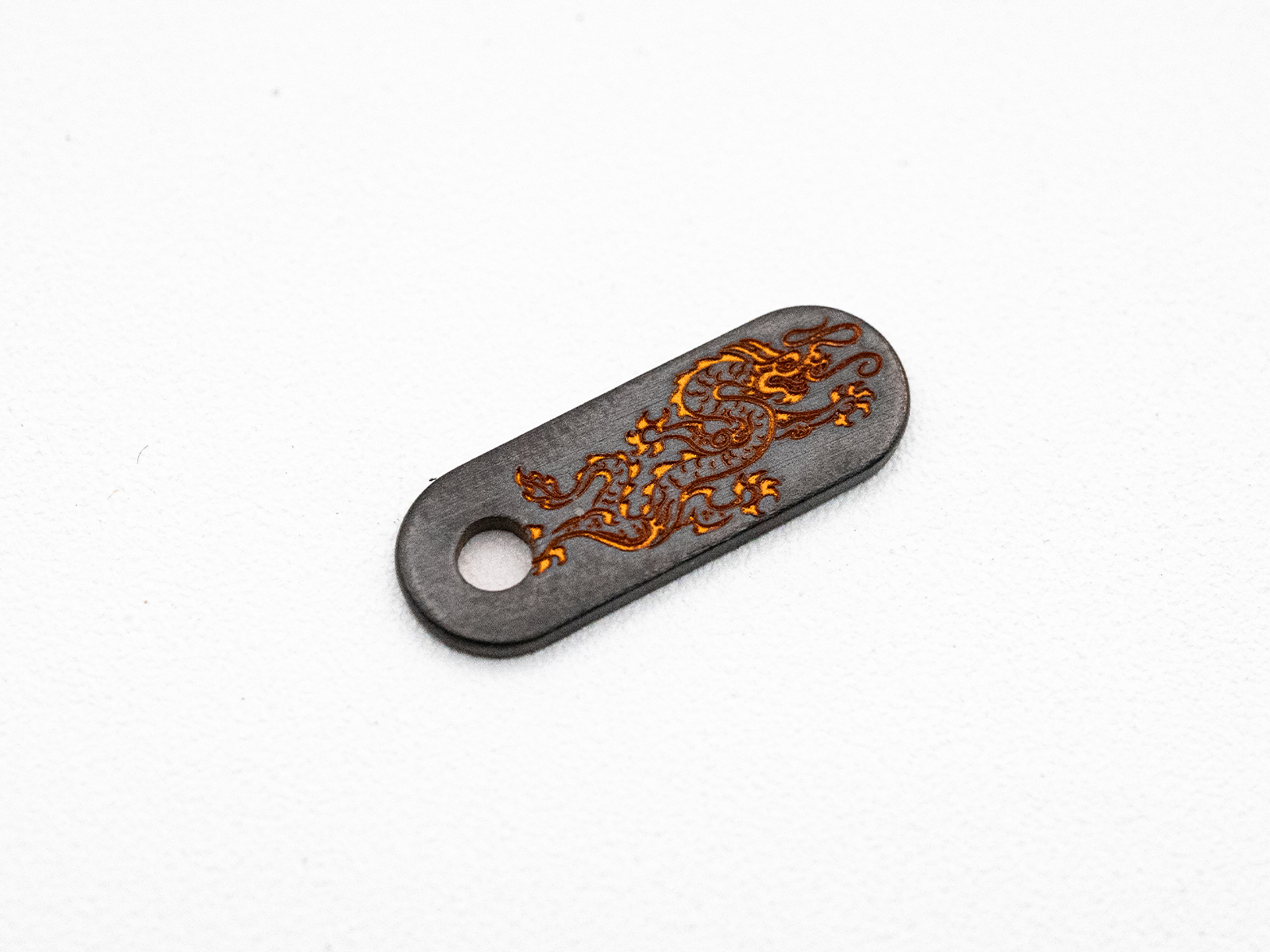 Hinderer Knives/Steel Flame Niobium Dragon Tab – Reversed Dragon - Brass Color Hinderer Knives/Steel Flame Niobium Dragon Tab – Reversed Dragon - Brass Color